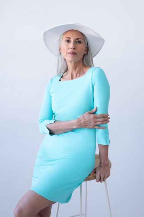 Stylish woman wearing a celeste Square Neck ¾ Sleeve Dress and hat, looking chic and sophisticated